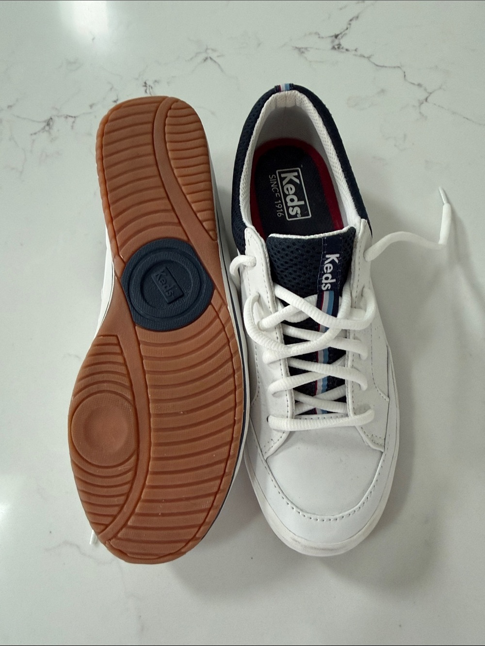 Keds women’s  White Leather Sneakers with Navy and Gum Sole . Like new